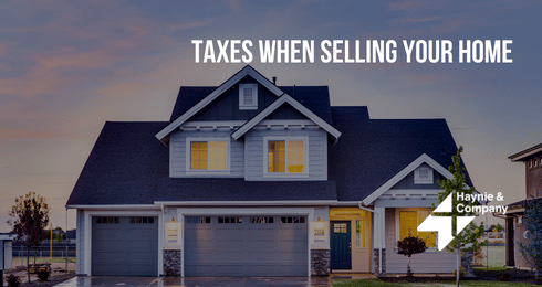 Two-story suburban house at dusk with text Taxes When Selling Your Home and Haynie logo.