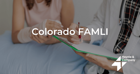 Colorado FAMLI: Doctor with clipboard assisting a person in a medical setting. Haynie logo present.