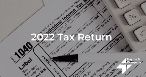 1040 tax form with pen and calculator for 2022 tax return.