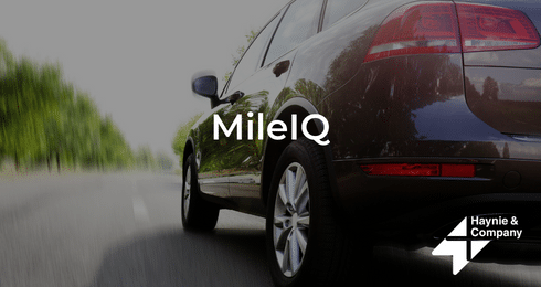 Car on road with MileIQ logo, showcasing Haynie branding.
