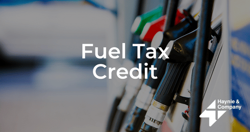 Fuel tax credit concept with gas pump nozzles and Haynie logo.