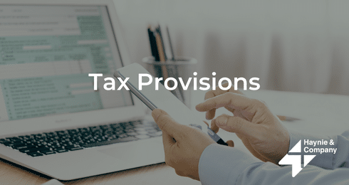 Person using phone with laptop on table, 'Tax Provisions' text, Haynie logo visible.