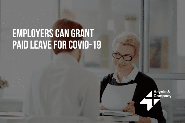 Business meeting discussing COVID-19 paid leave policy at Haynie office.
