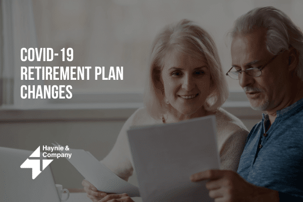 Older couple reviewing COVID-19 retirement plan changes documents at home.