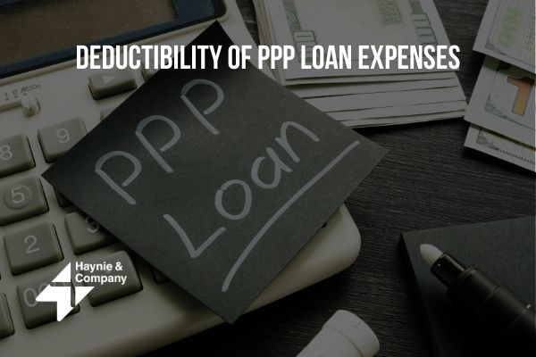 Deductibility of PPP loan expenses with calculator and money.