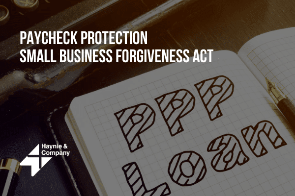 Notebook with PPP Loan text, related to Paycheck Protection Small Business Forgiveness Act.