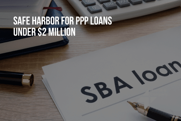 SBA loan document on a desk with a pen and calculator, discussing PPP loans under $2 million.