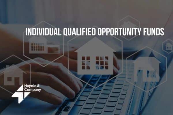 Keyboard with housing icons and Individual Qualified Opportunity Funds text overlay.