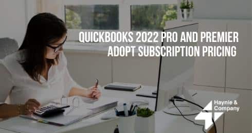 Woman working at a desk with a calculator, QuickBooks 2022 Pro and Premier adopt subscription pricing text displayed.