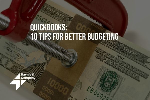 QuickBooks budgeting tips image with money in a clamp, promoting Haynie advice.
