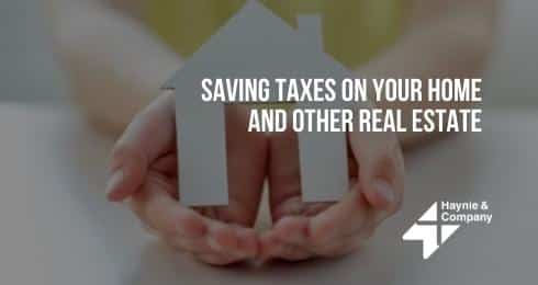 Hands holding a house cutout with text 'Saving Taxes on Your Home and Other Real Estate' by Haynie.