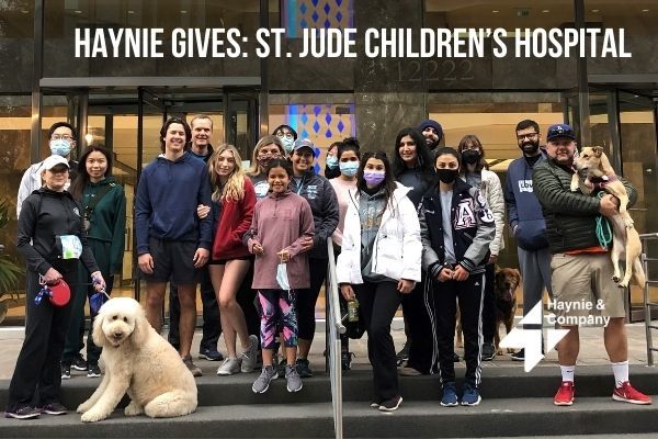 Group of people and dogs posing for Haynie Gives: St. Jude Children's Hospital charity event.