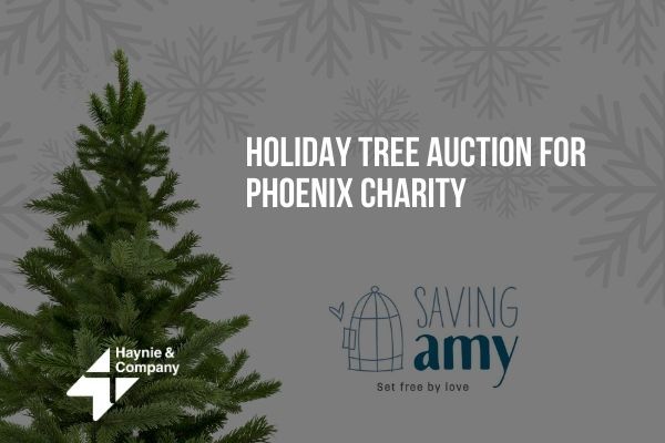 Holiday tree auction for Phoenix charity, featuring logos for Saving Amy and Haynie.