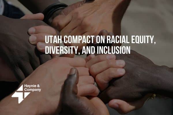 Hands of diverse people united, promoting Utah Compact on Racial Equity, Diversity, and Inclusion.