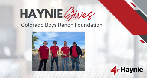 Haynie Gives event supporting Colorado Boys Ranch Foundation with four participants in red shirts holding gear.