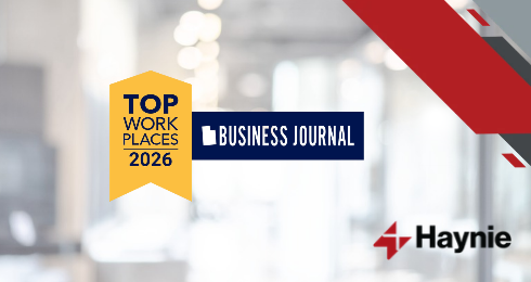 Top Workplaces 2026 award by Business Journal, Haynie logo on a blurred office background.